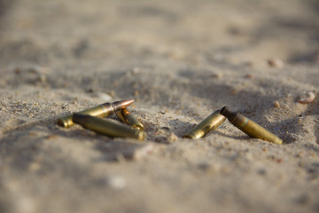 Shell casing of automatic weapons on the sand. signs of war