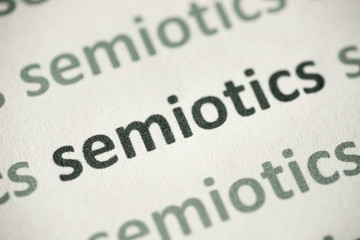 word semiotics printed on paper macro