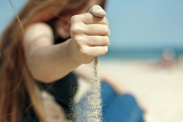 strewing sand from hand