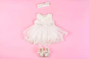 Beautiful baby dress with booties on a pink