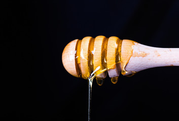 Spoon with honey. Honey sticks with a spoon
