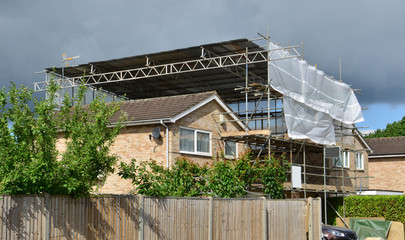 A Scaffold tower attached to a detached house in the UK
