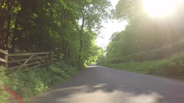 POV Driving through the Quantock Hills in Somerset, England downhill warning signs along the road