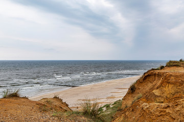 View to the red cliff at Kampen where storms repeatedly break off parts of the cliff at Sylt /...