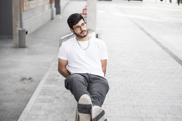 man with a beard leaning on a handrail