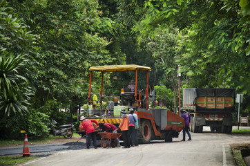 Fototapeta na wymiar Thai workers working with heavy machinery construction site repair surface of road at Kamphaeng Phet Historical Park