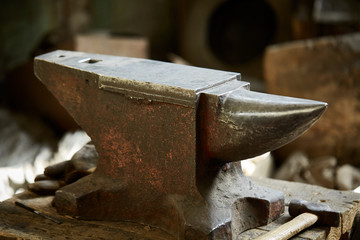 Big heavy anvil in the blacksmith's workshop, close-up, selective focus.