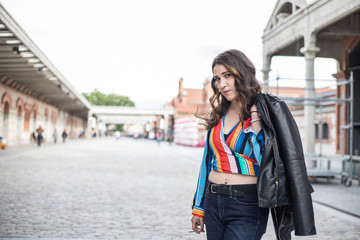Fototapeta premium Woman in the street with windbreaker on the shoulder