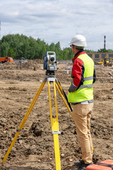 The surveyor is shooting at a building site