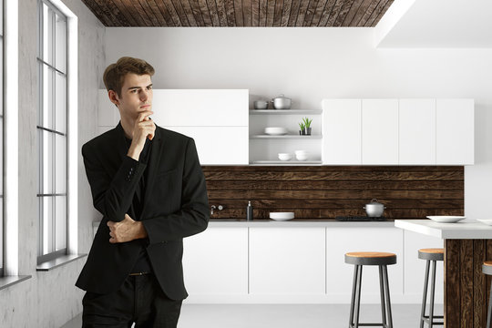 Handsome businessman in modern kitchen interior