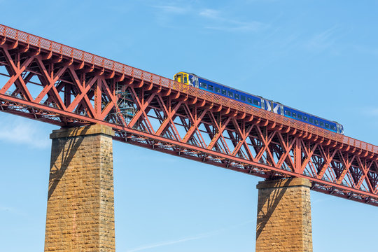 Fototapeta Forth Bridge, railway bridge over Firth of Forth near Queensferry in Scotland with train passing the bridge