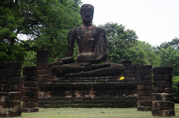View landscape of buddha statue at Wat Phra Sing in ancient building and ruins city of Kamphaeng Phet Historical Park