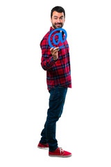 Naklejka premium Handsome man holding icon of at dot com