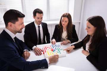 Businesspeople Holding Multi Colored Arrow Solving Maze