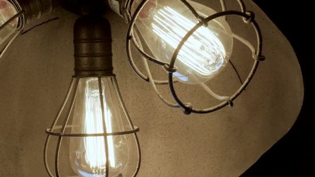 Interior of room. Close-up shot of modern lighting lamp with light bulbs. 4K