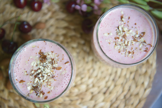 Cherry smoothies with nuts on the table. Selective focus
