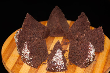 homemade chocolate cake with sesame seeds, sliced on a board