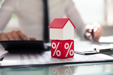 House Model Over Dice With Percentage Symbol
