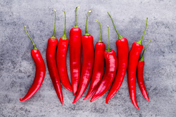 Chili cayenne pepper on grey background.