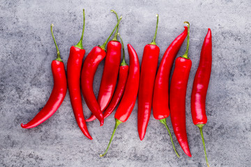 Chili cayenne pepper on grey background.