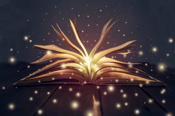 sparks fly from the book. glowing lights. Symbols of thoughts and knowledge.