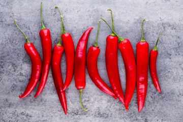 Chili cayenne pepper on grey background.