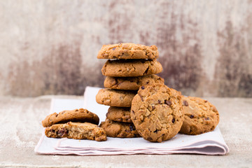 Chocolate oatmeal cookies on the wooden background.