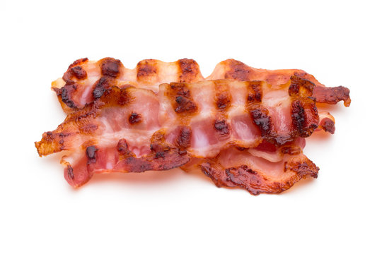 Cooked bacon rashers isolated on white.