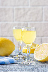 Italian traditional liqueur limoncello with lemon