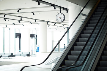 Empty escalator moving downwards or upwards inside modern airport