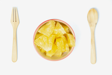 Pineapple in bowl on white background.