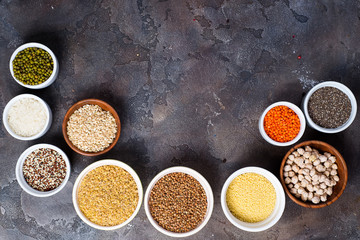 Superfoods and cereals selection in bowls on grey concrete background