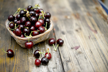 cestino di ciliegie su tavola di legno