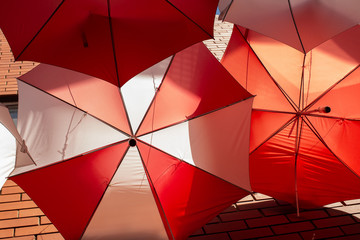 Display of red and white umbrellas