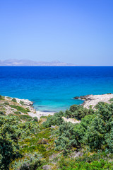Beach, Greece - Kos Island, Kefalos: Picturesque deep blue Caribbean Bay with wild sea of ​​Greek Agais and steep sandstone cliffs, perfect for wind surfers with heavy waves