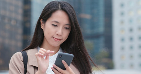 Fototapeta premium Woman use of mobile phone at outdoor