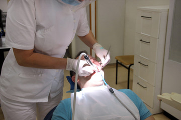 Dental check up. Dental male patient at regular dental check, at dental clinic and office. Man with...