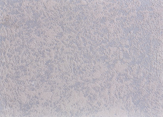 White plastered wall background with abstract pattern, close-up, macro.