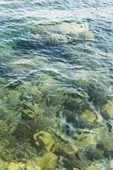 Fototapeta na wymiar adriatic sea water waves with stones in shallow