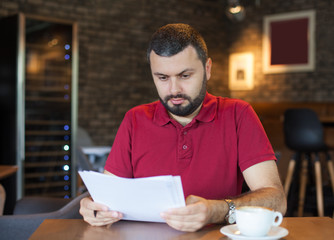 Worried man looking at paper