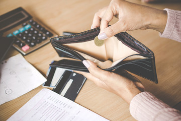 poor Asian woman hand open empty purse with only one coin left bankrupt broke after credit card payday