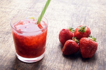 Sweet fresh strawberry juice, smoothies on the wooden table, selective focus