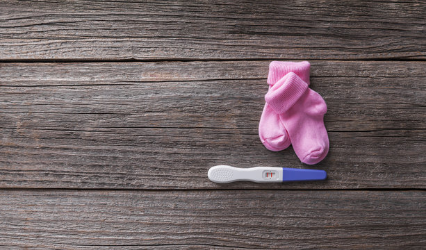 Pregnancy test and baby socks.
