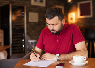 Portrait of handsome man writing a letter