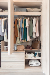 wooden closet with colorful clothes