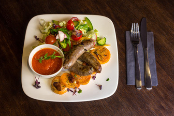 Fried sausages and salad