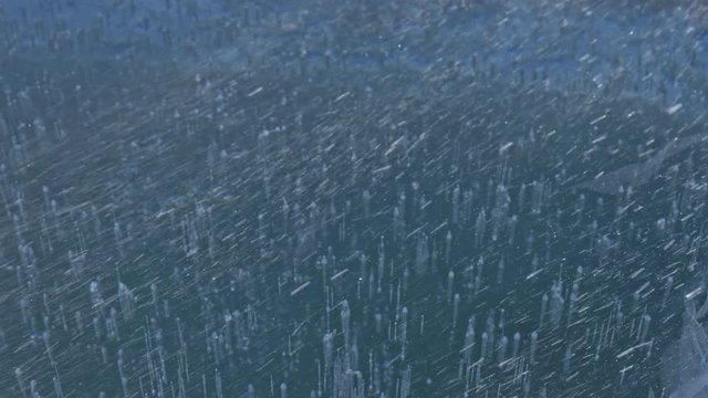 Snow is flying over surface of ice. Snowflakes fly on ice of Lake Baikal. Ice is very beautiful with unusual unique cracks. Snow sparkles and glows in red. Shooting slow motion 60fps. Picture at