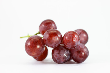 Red grapes on white background.
