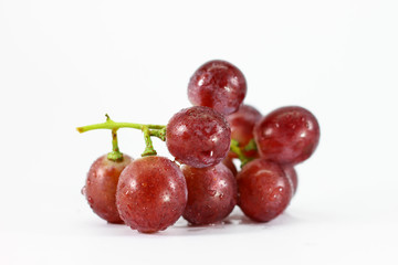 Red grapes on white background.