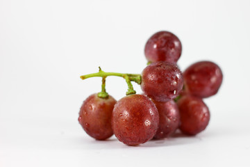 Red grapes on white background.